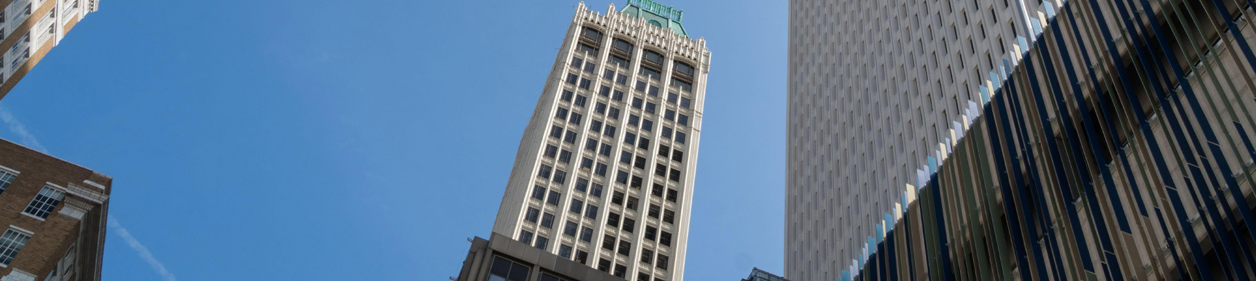 A view, looking up, to a building in downtown Tulsa during the day